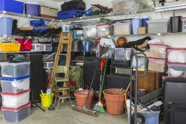 Inside of a messy Joliet garage with a pest problem.